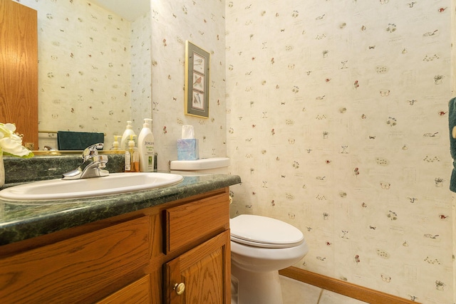 bathroom featuring tile patterned flooring, vanity, and toilet