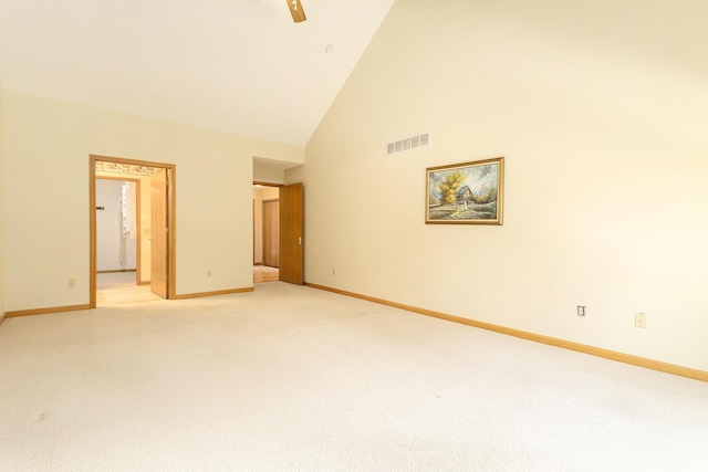 carpeted empty room featuring ceiling fan and high vaulted ceiling