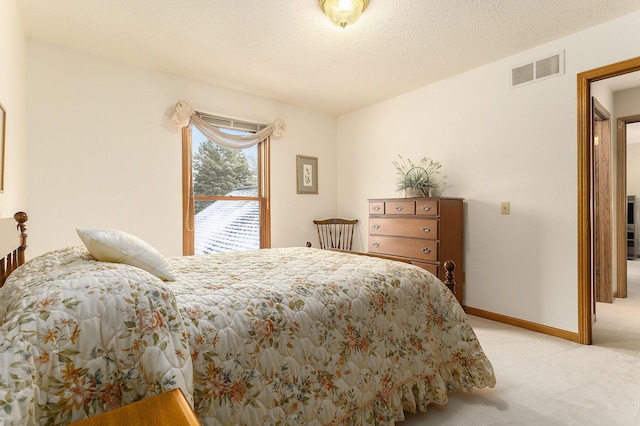 carpeted bedroom with a textured ceiling