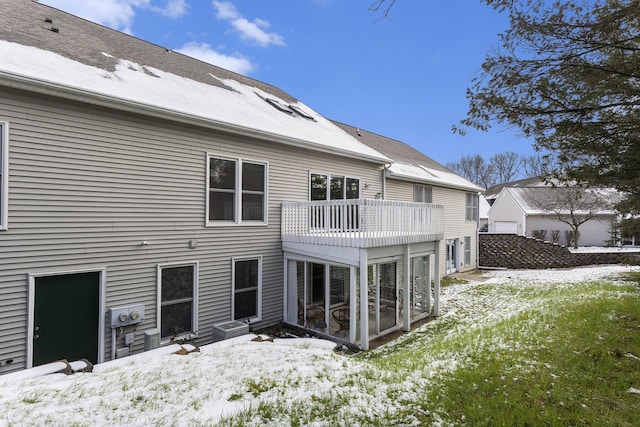 snow covered property featuring a balcony