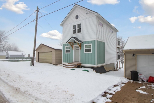 front facade with an outbuilding and a garage