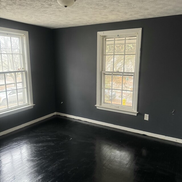 spare room with a textured ceiling