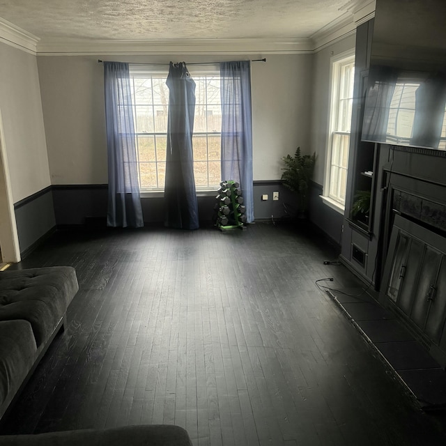 unfurnished living room with a fireplace, dark hardwood / wood-style flooring, and crown molding