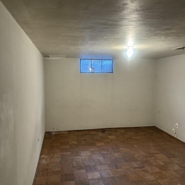 basement with dark parquet floors