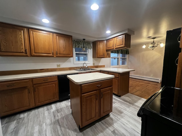 kitchen featuring a center island, an inviting chandelier, a baseboard heating unit, sink, and light hardwood / wood-style floors