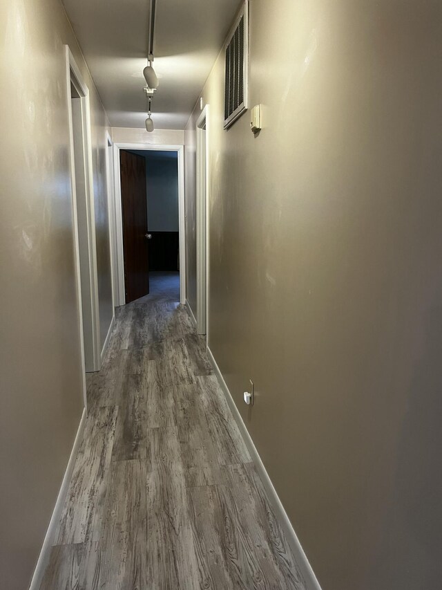 hallway with dark hardwood / wood-style floors