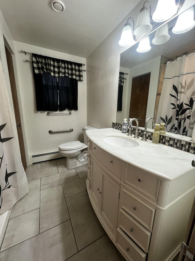 bathroom with tile patterned floors, toilet, vanity, and a baseboard heating unit