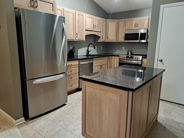 kitchen featuring light tile patterned flooring, appliances with stainless steel finishes, dark stone counters, and sink