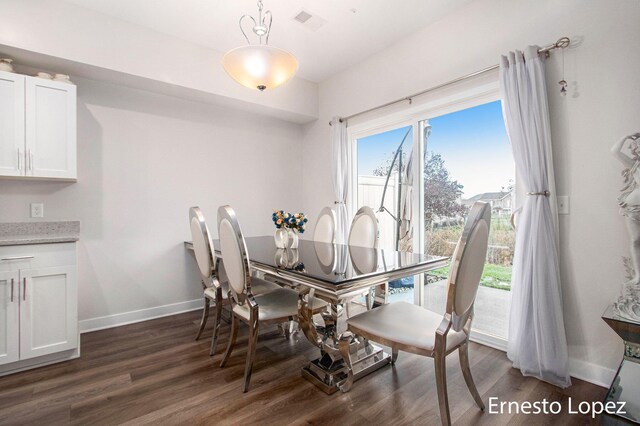 dining area with dark hardwood / wood-style floors