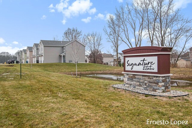 community sign featuring a yard