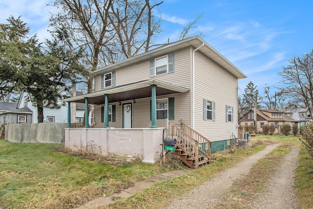 view of front of home with a porch and a front lawn