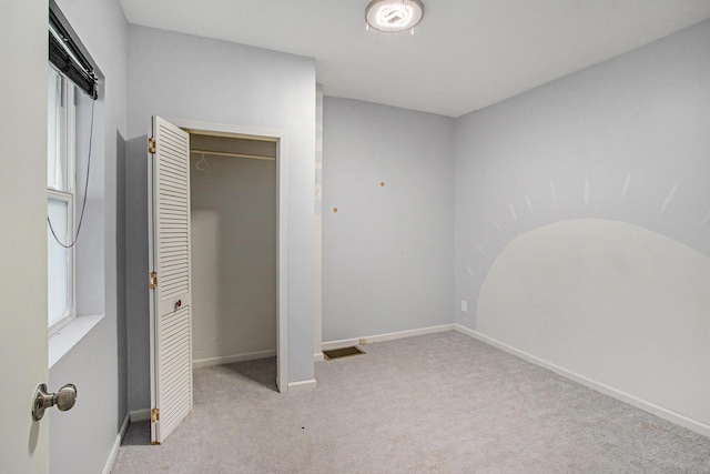 unfurnished bedroom featuring light colored carpet