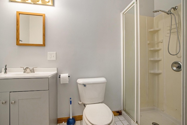 bathroom featuring tile patterned floors, vanity, toilet, and walk in shower