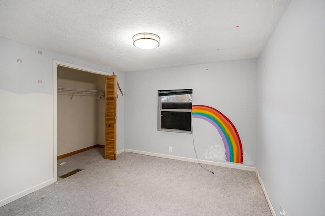 unfurnished bedroom featuring a closet, light colored carpet, and a textured ceiling