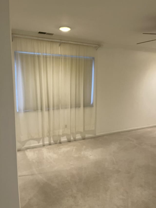 empty room with ceiling fan and carpet floors