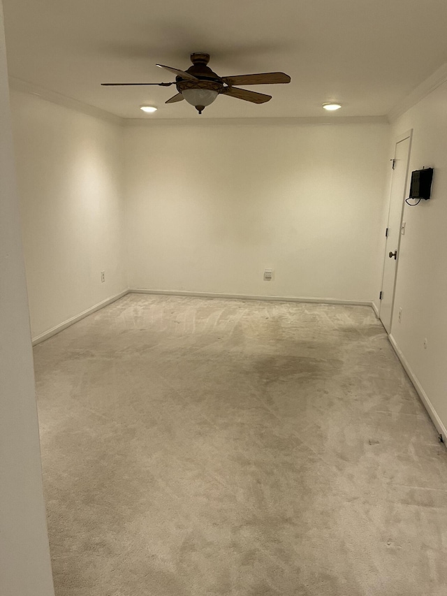 carpeted empty room with crown molding and ceiling fan