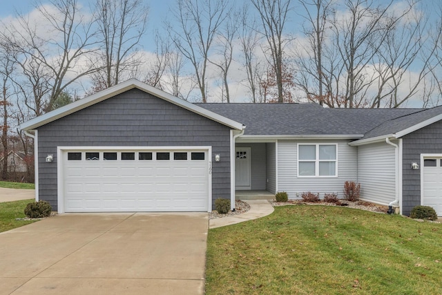 single story home with a garage and a front lawn