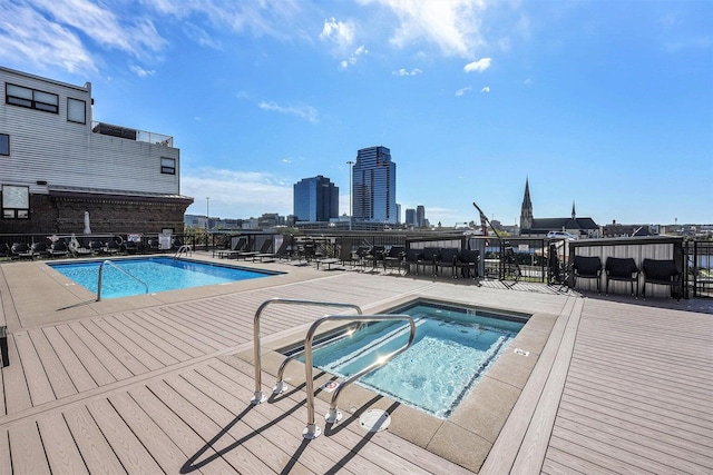 view of pool with a patio area and a hot tub