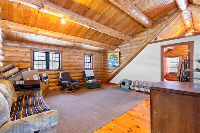 living room with beamed ceiling, hardwood / wood-style flooring, a healthy amount of sunlight, and wood ceiling