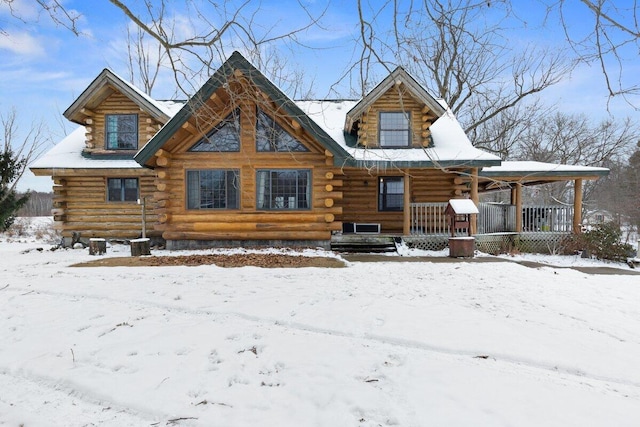 log cabin featuring covered porch