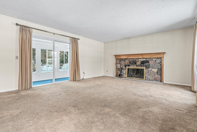 unfurnished living room featuring carpet flooring, a fireplace, and a textured ceiling