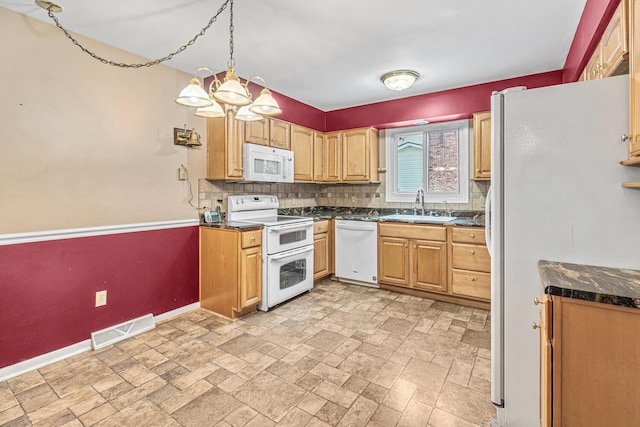 kitchen featuring sink, tasteful backsplash, a chandelier, pendant lighting, and white appliances