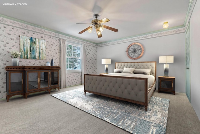 carpeted bedroom featuring ceiling fan and ornamental molding