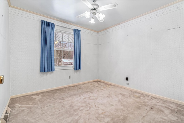 spare room with carpet flooring, crown molding, and ceiling fan