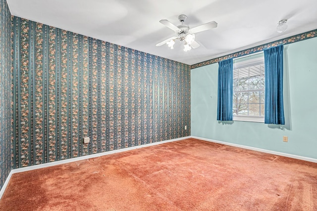 spare room featuring carpet and ceiling fan