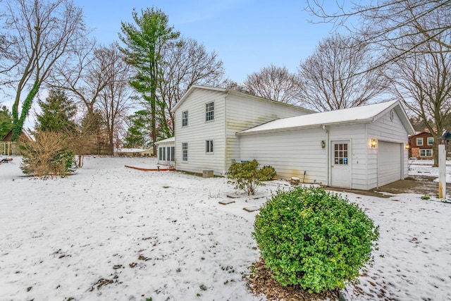 snow covered property with a sunroom