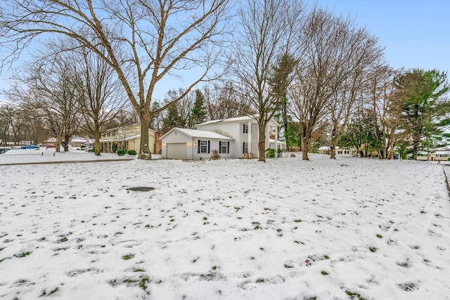 yard covered in snow with a garage