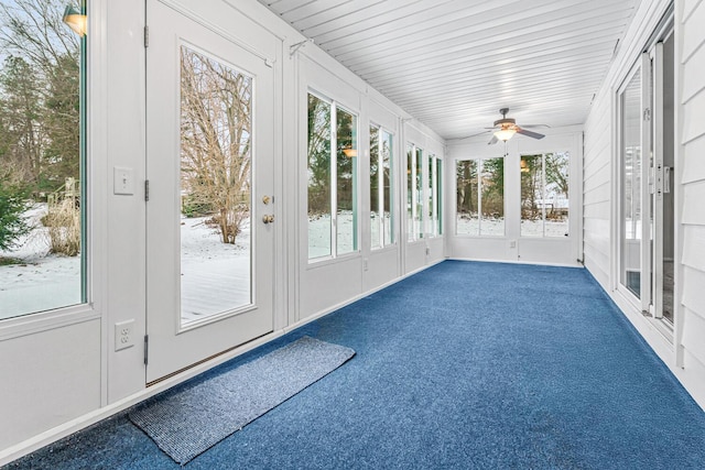 unfurnished sunroom with a wealth of natural light and ceiling fan