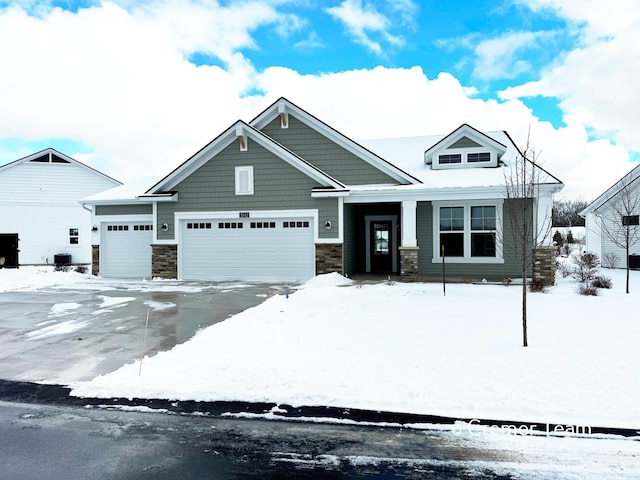 craftsman-style house with a garage and cooling unit