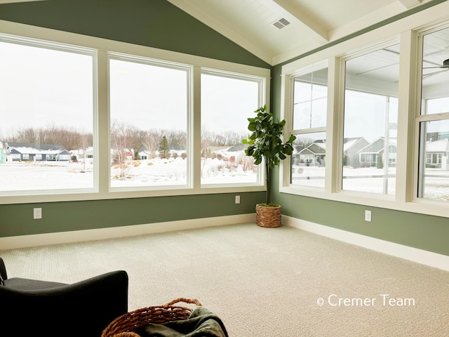 sunroom / solarium with a wealth of natural light and vaulted ceiling with beams