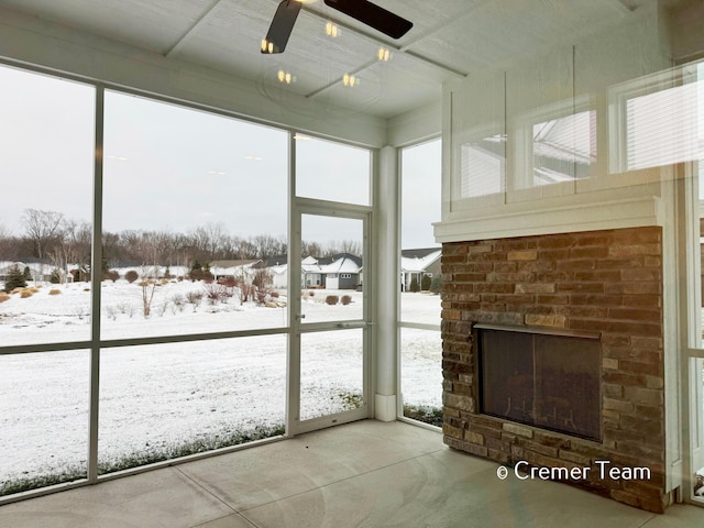 unfurnished sunroom with a brick fireplace