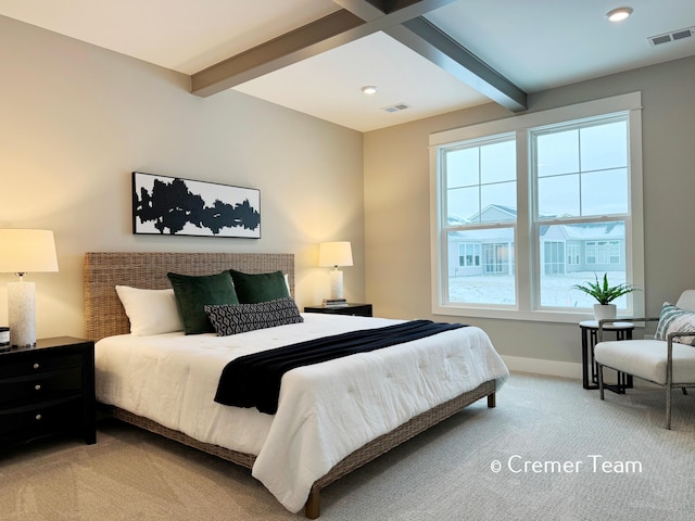 bedroom featuring beam ceiling and light carpet