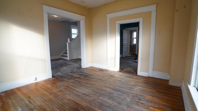 spare room with dark wood-type flooring