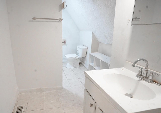 bathroom with tile patterned floors, toilet, a textured ceiling, vanity, and lofted ceiling