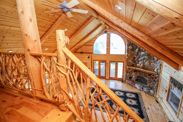 stairs featuring beamed ceiling, wooden ceiling, and hardwood / wood-style floors