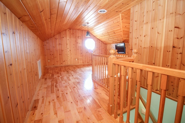 bonus room featuring wood-type flooring, wooden walls, vaulted ceiling, and wooden ceiling