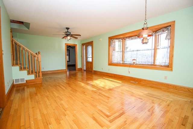 unfurnished living room featuring ceiling fan and light hardwood / wood-style floors