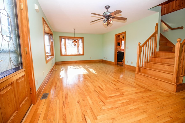 unfurnished living room featuring ceiling fan and light wood-type flooring