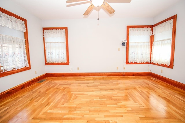 unfurnished room featuring ceiling fan and light parquet flooring