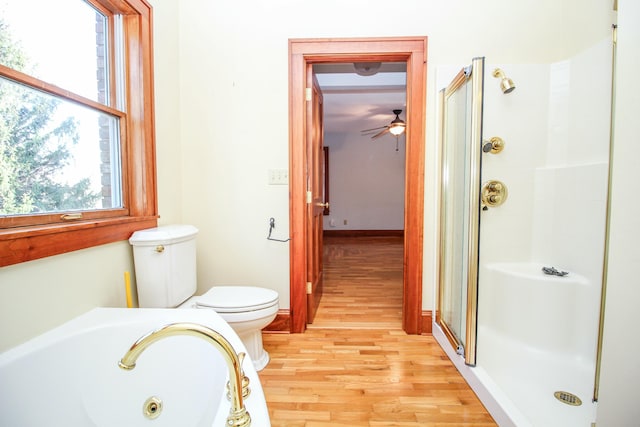 bathroom with hardwood / wood-style flooring, plenty of natural light, and plus walk in shower