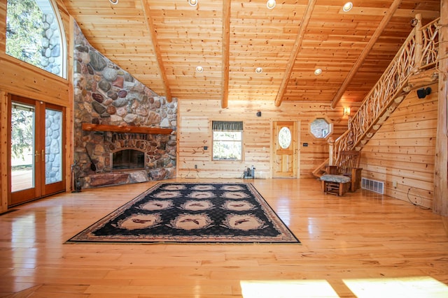 unfurnished living room with beamed ceiling, wooden ceiling, and a wealth of natural light