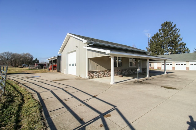 exterior space with covered porch and a garage