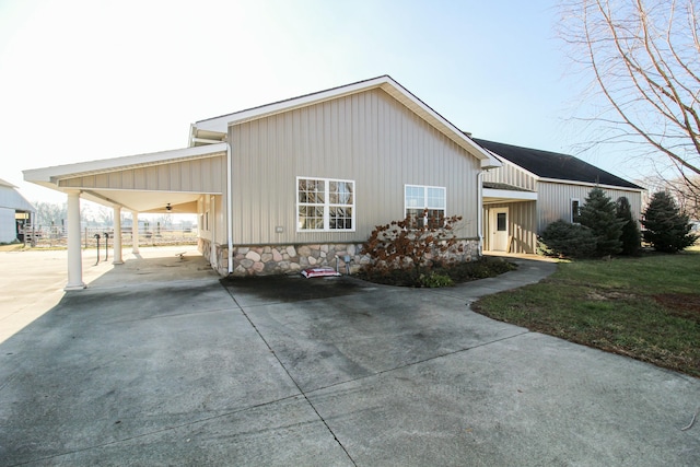 exterior space with a carport and a yard