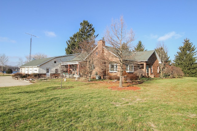 back of property featuring a lawn