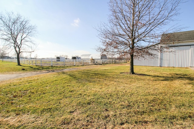 view of yard with a rural view and an outdoor structure