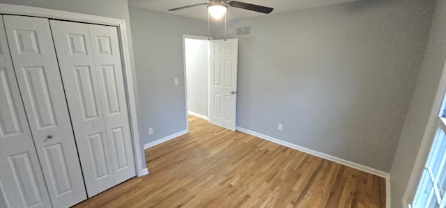 unfurnished bedroom featuring ceiling fan, a closet, and light hardwood / wood-style flooring